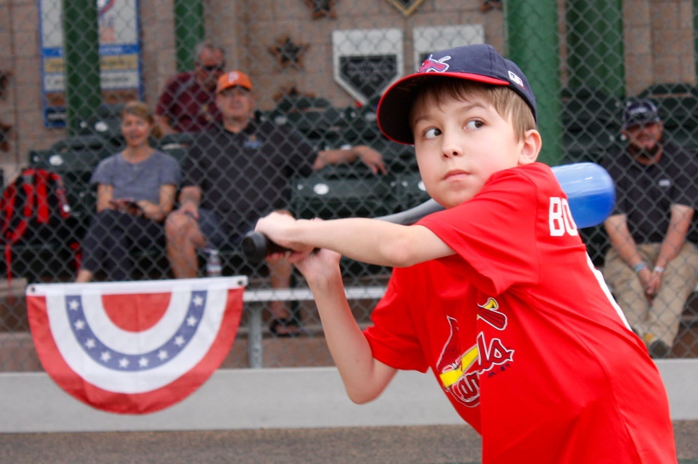 A young boy swinging a baseball bat.