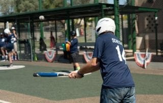 A man swinging a baseball bat on a field.
