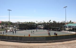 A baseball field with people playing on it.