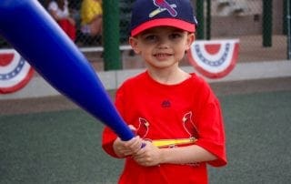 A young boy holding a baseball bat.