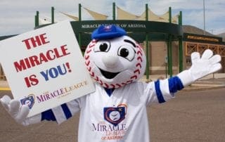 A mascot holding up a sign.