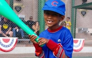 A young boy holding a bat.