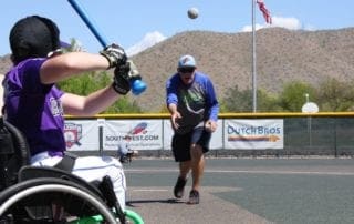 A man in a wheelchair is throwing a ball.