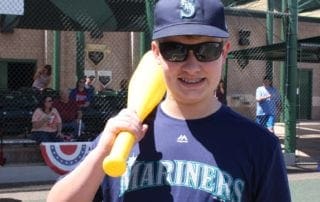 A young man holding a baseball bat.