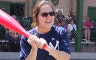 A woman holding a baseball bat.