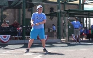 A man is swinging a bat at a baseball game.