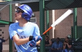 A young man swinging a baseball bat.