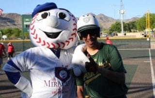 A man is posing with a mascot.