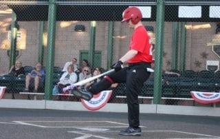 A baseball player swinging a bat in front of a crowd.
