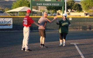 A group of people playing a game of baseball.