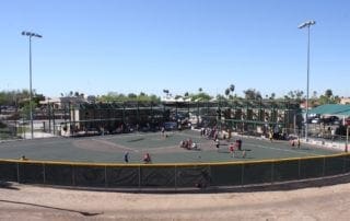 A baseball field with people playing on it.