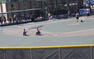 A person in a wheelchair on a baseball field.