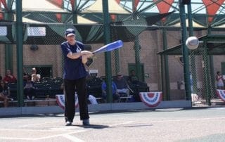 A man swinging a baseball bat at a ball.