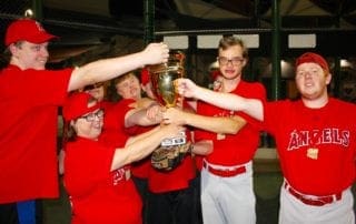 A group of people holding up a trophy.