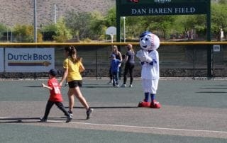 A baseball field with a mascot.
