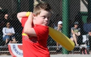 A young boy swinging a baseball bat.