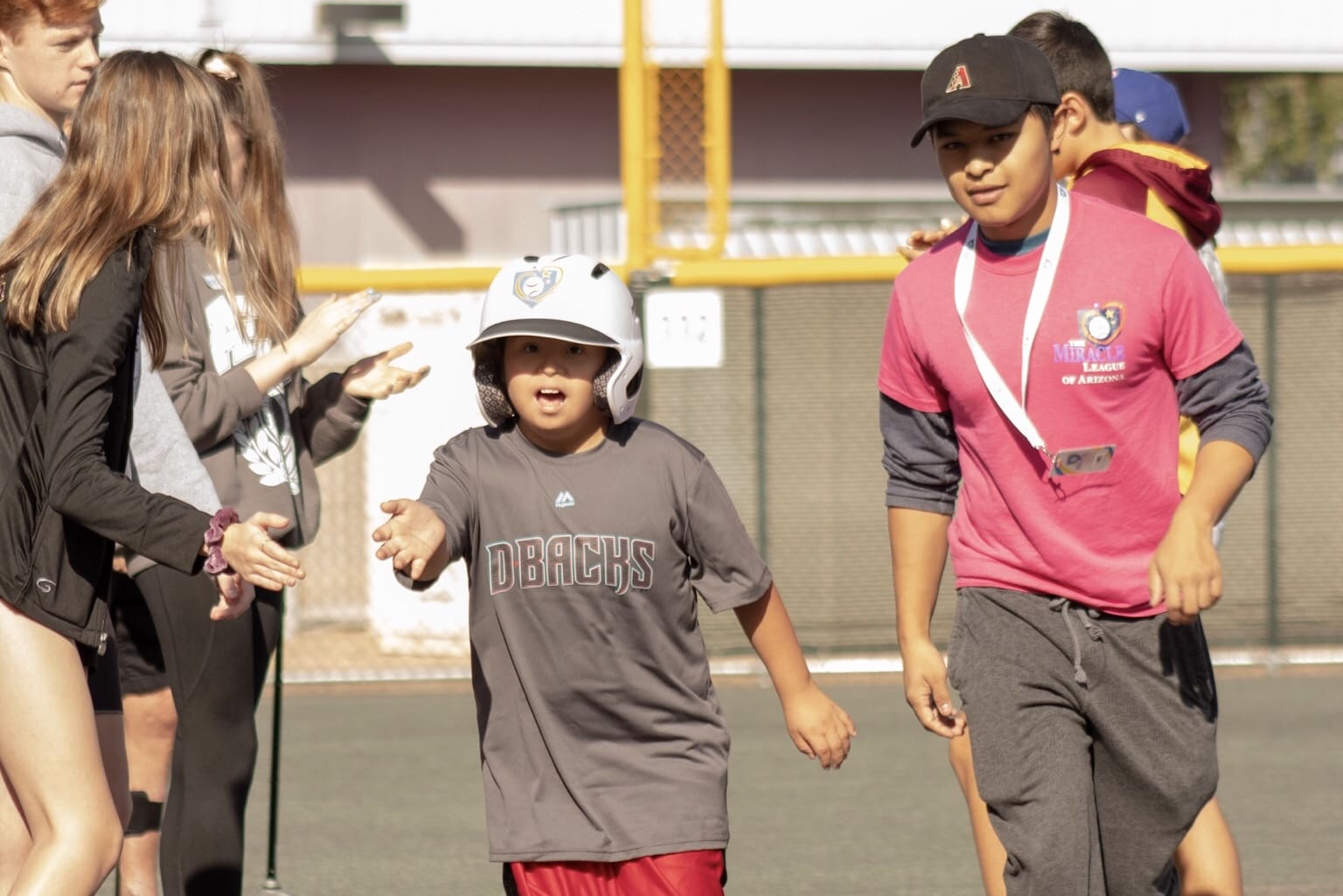 A group of young people on a baseball field.