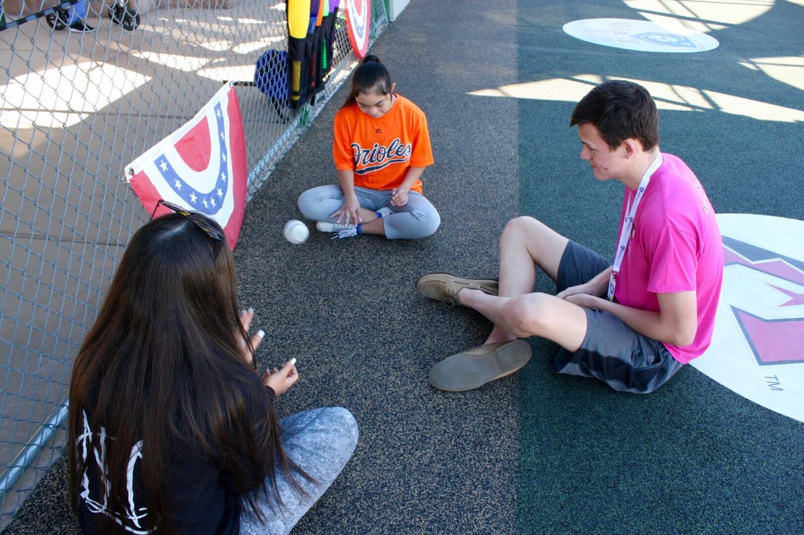 A group of people sitting on the ground.