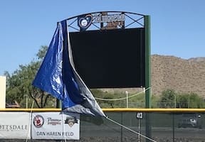 A baseball field with a blue flag on it.