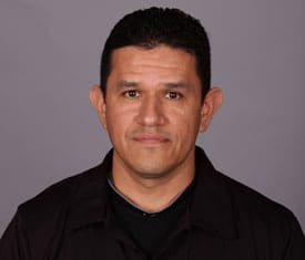 A man in a black shirt is posing for a photo.