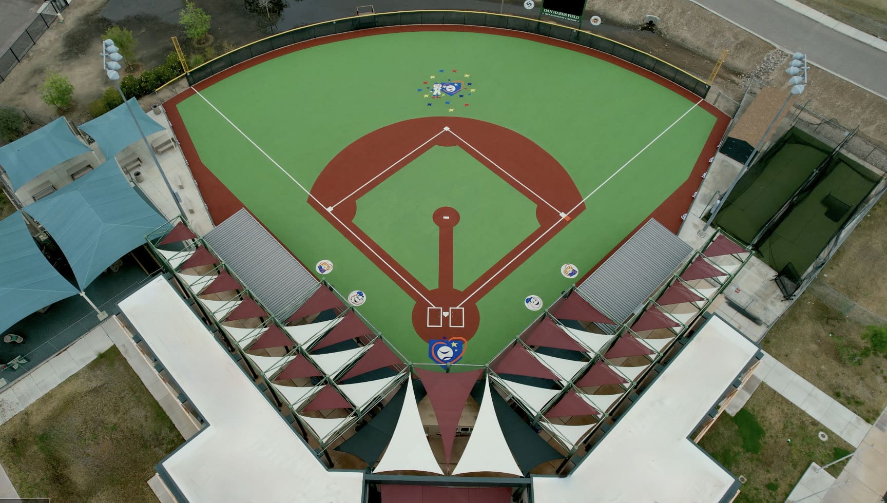 A baseball field with the diamond in the middle of it.