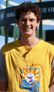 A man in yellow shirt smiling for the camera.