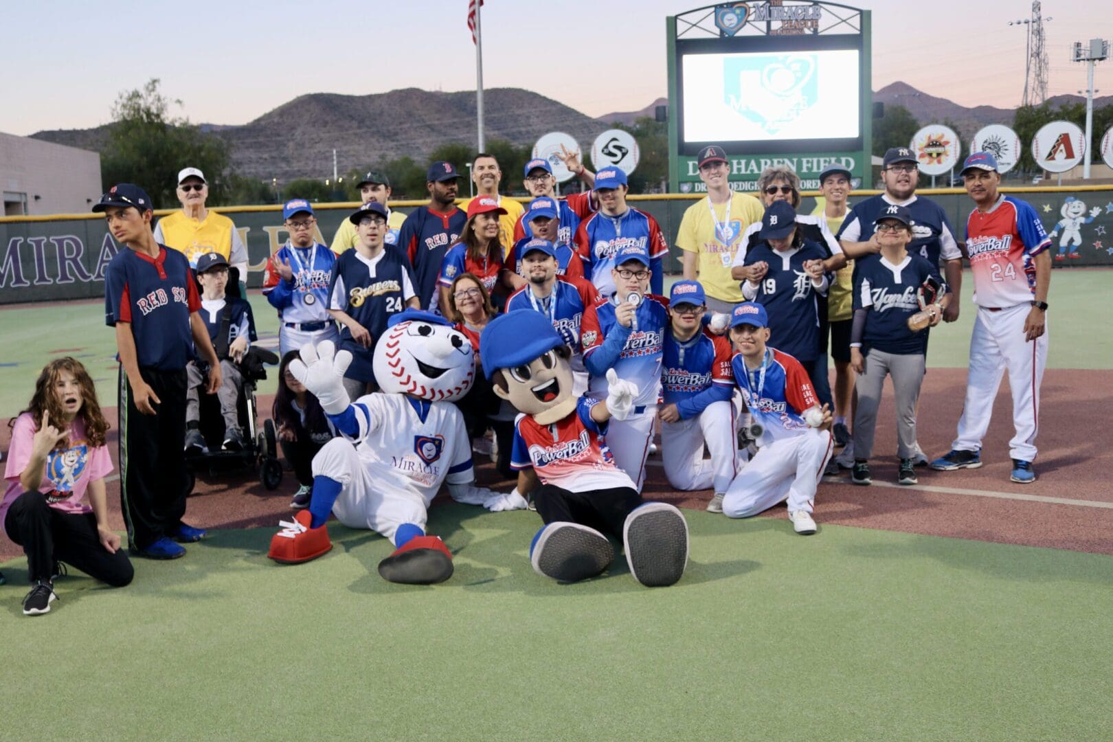 A group of baseball players and mascots posing for a photo.