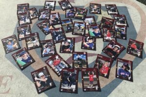 A group of baseball cards laying on the ground.