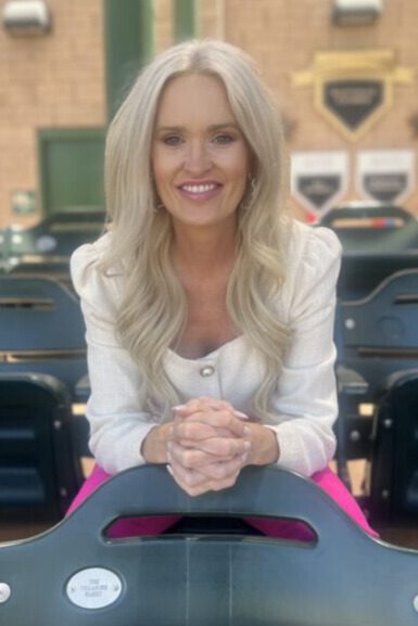 Woman with blonde hair smiles at the camera.