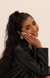 Smiling woman with long dark hair.